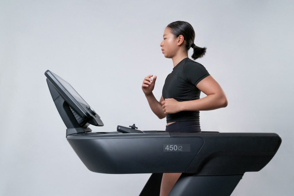 A person indoor running on a treadmill