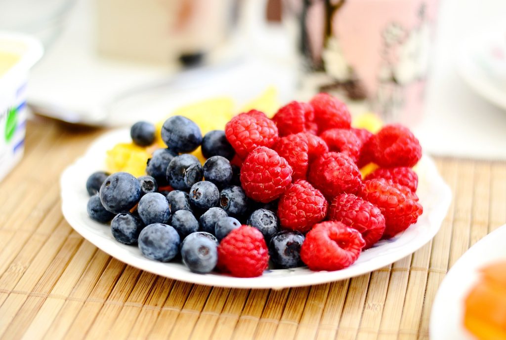 blueberries and raspberries are part of a targeted diet on a white plate