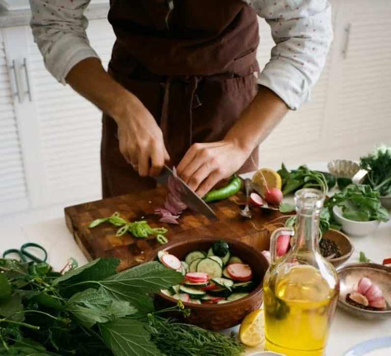 a person slicing vegetables on chopping board part of a targeted diet
