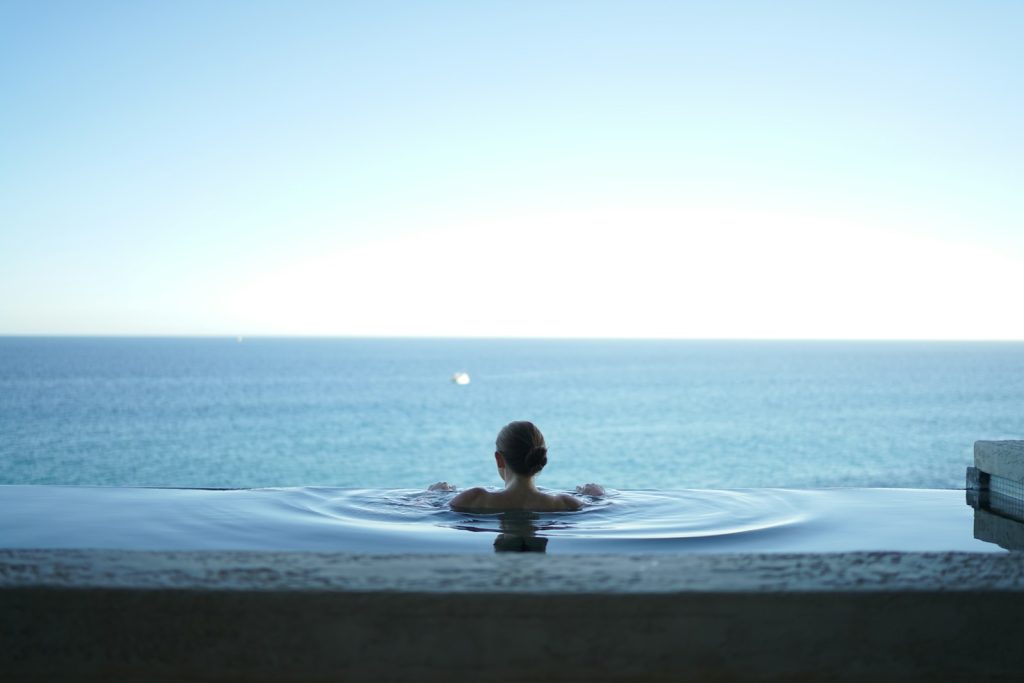 A woman in a water pool relaxing after an advanced-level diet and exercise masterclass